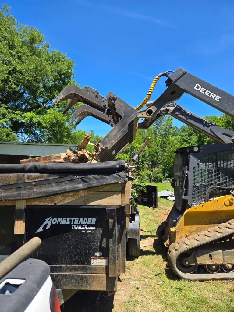 Heavy equipment from Cutting Edge Lawn and Landscapes hauling away concrete debris in Spring Hill, TN, showcasing their demolition services.