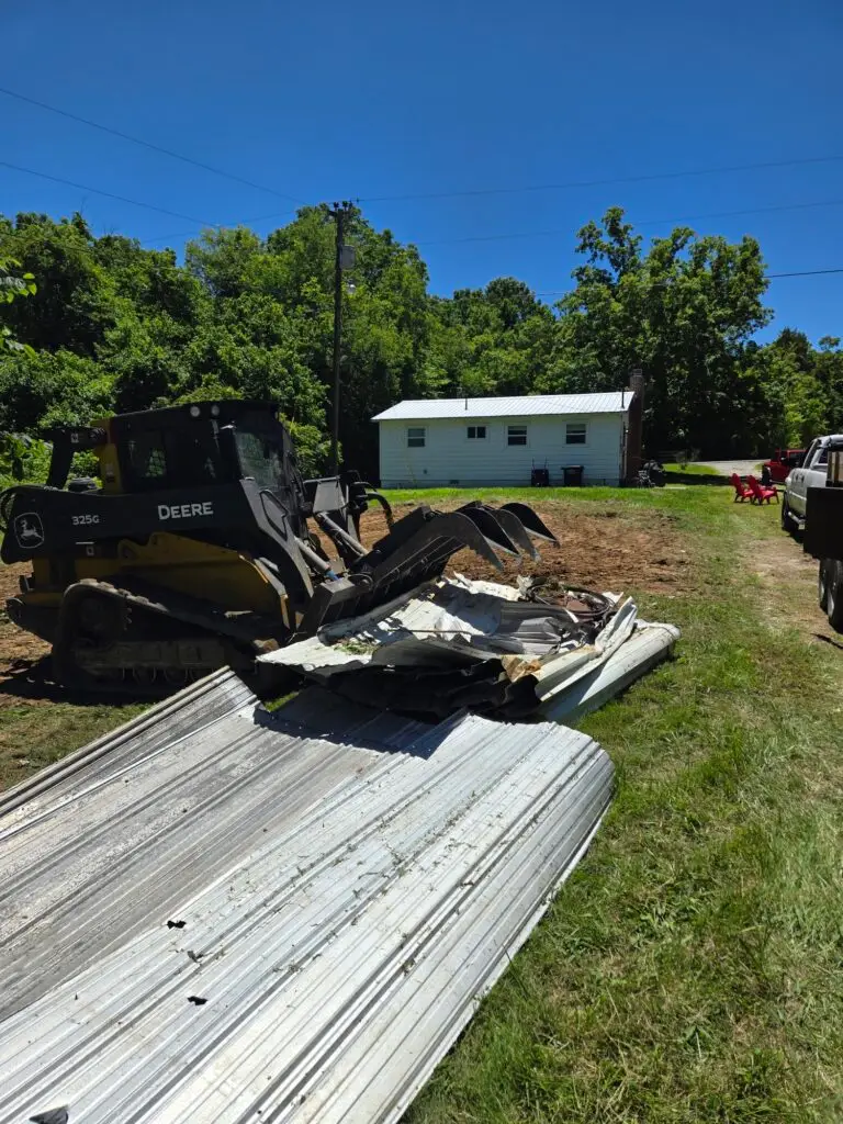 Heavy machinery from Cutting Edge Lawn and Landscapes loading debris into a truck in Spring Hill, TN, as part of a land management project. Removal of an old building to prepare for a new landscaping project.