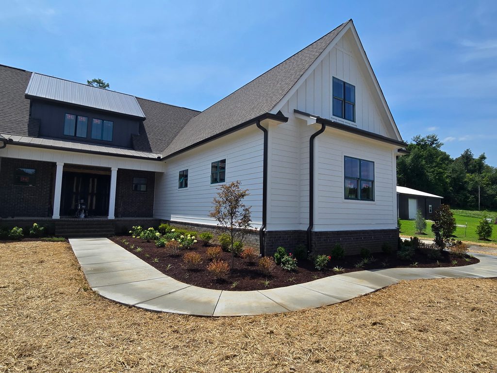 New landscape bed with trees, shrubs and flowering plants at a Culleoka TN home