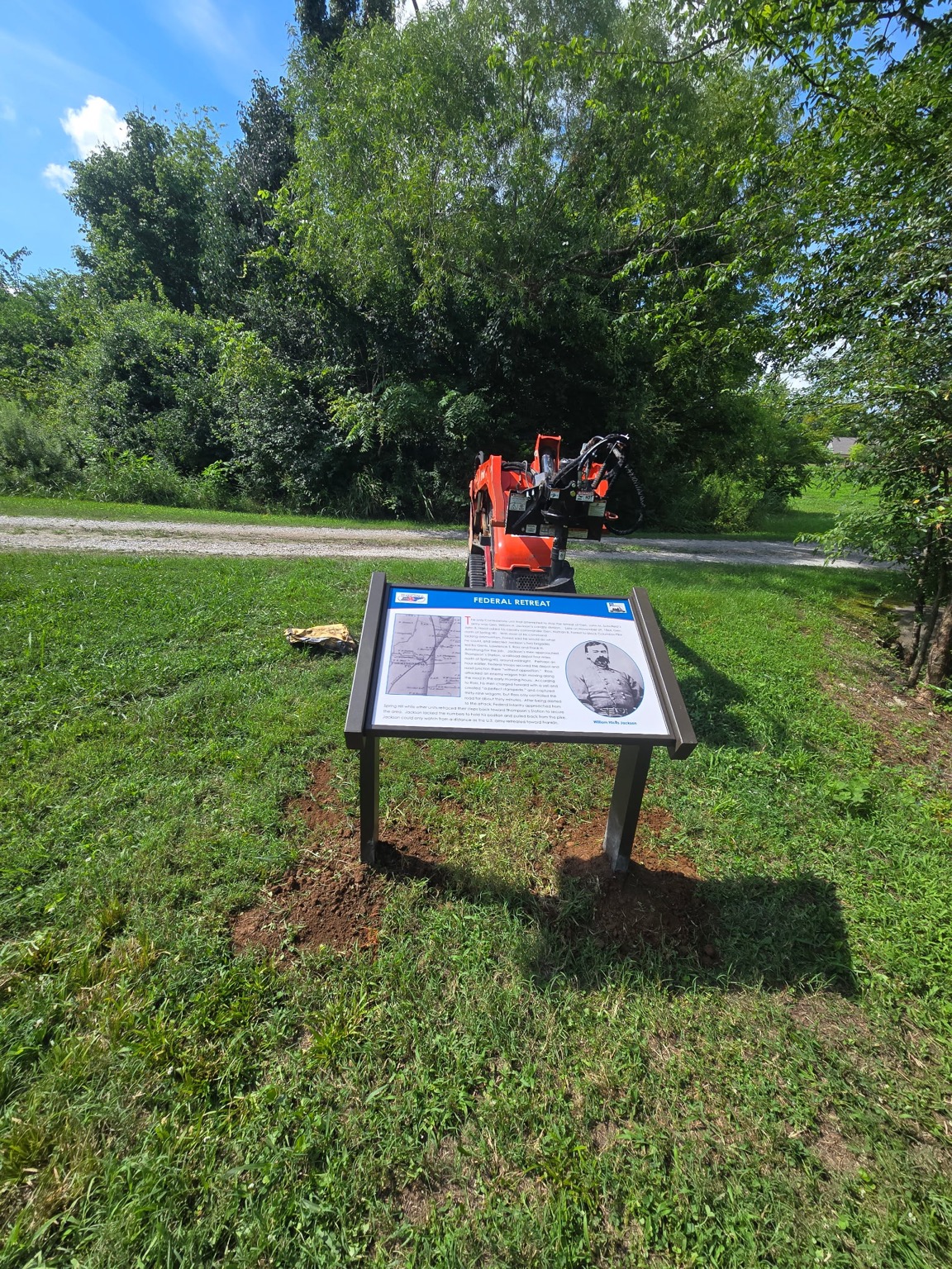 Auger equipment behind the installed Federal Retreat interpretive sign in Spring Hill